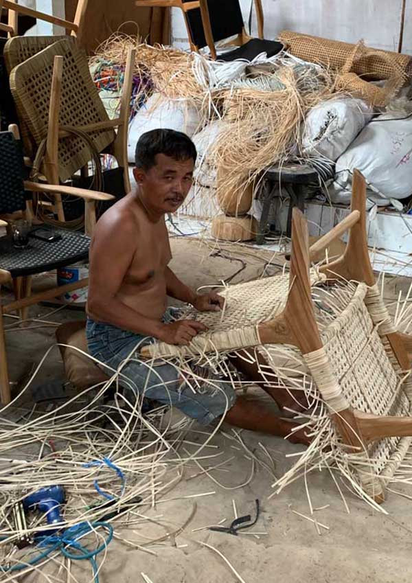 man weaving rattan 