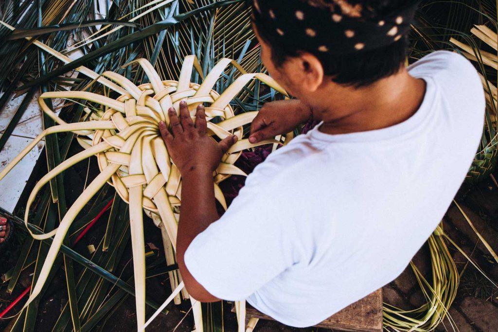 man weaving leaves